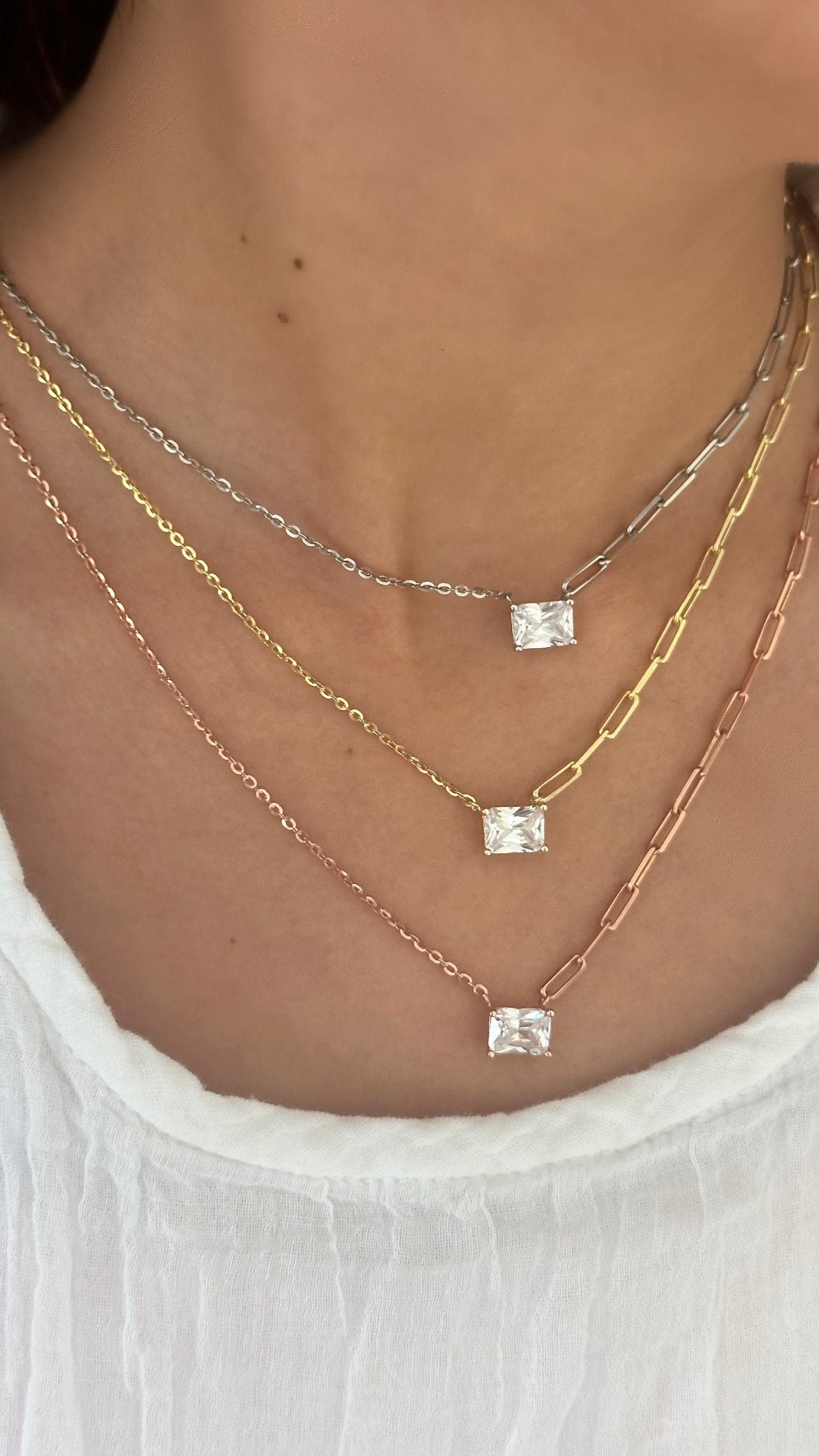 Minimalist emerald cut necklace worn on neck
