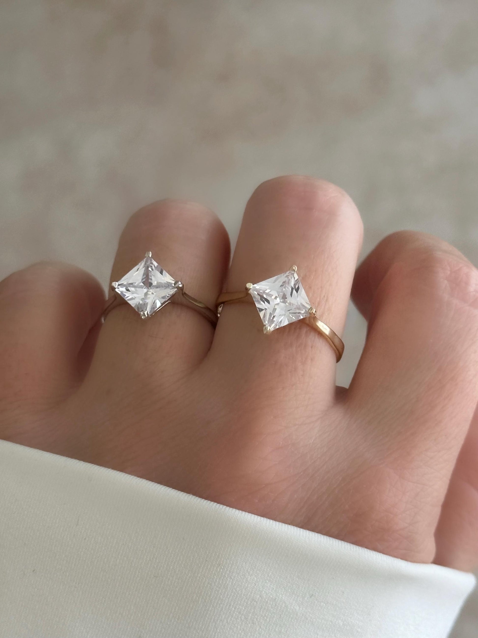 Silver Adjustable Diamond Ring ‚Äì Rhodium plated sterling silver solitaire ring with princess cut CZ stone.