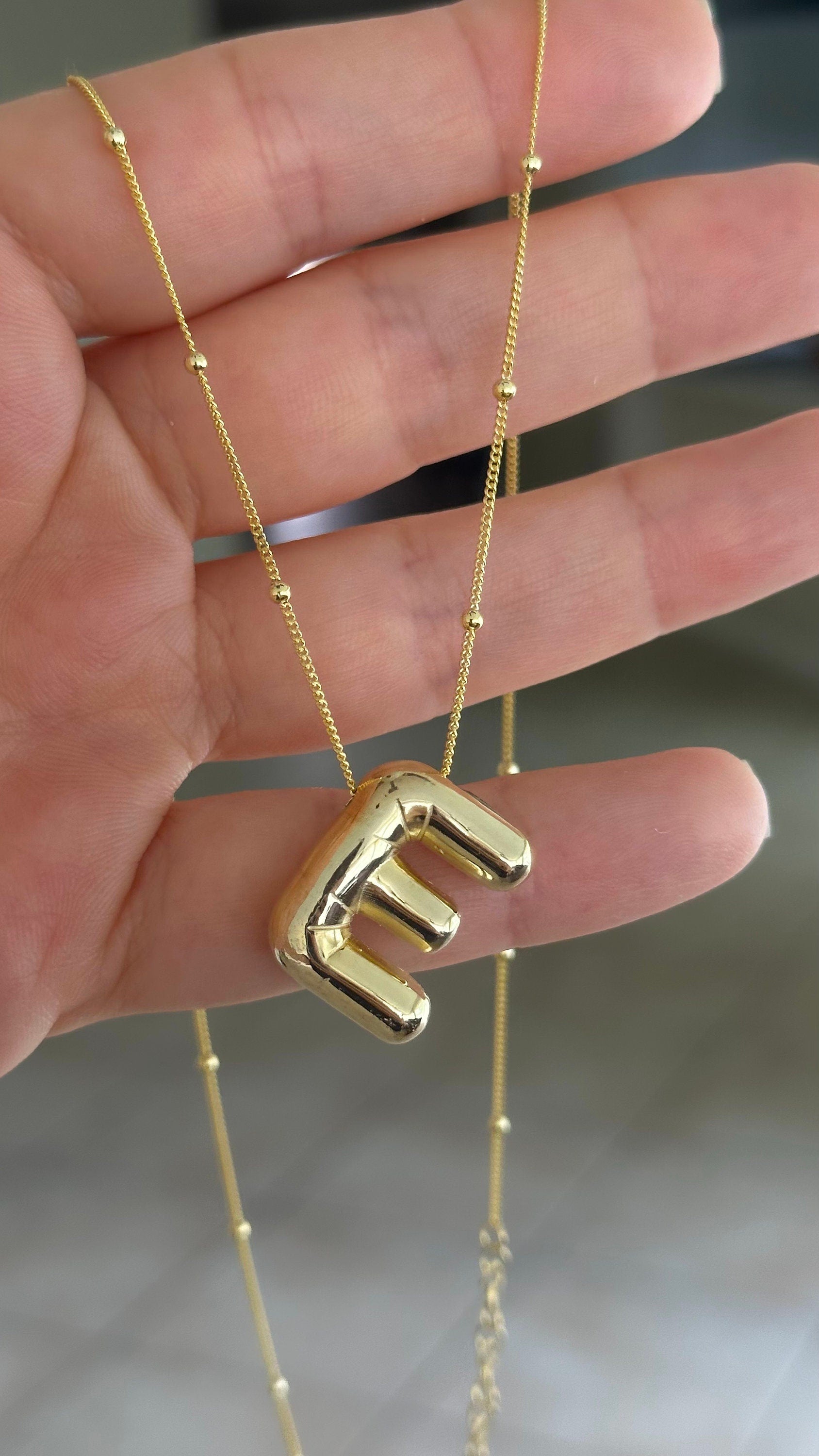 Statement necklace with gold plated bubble letter chunky