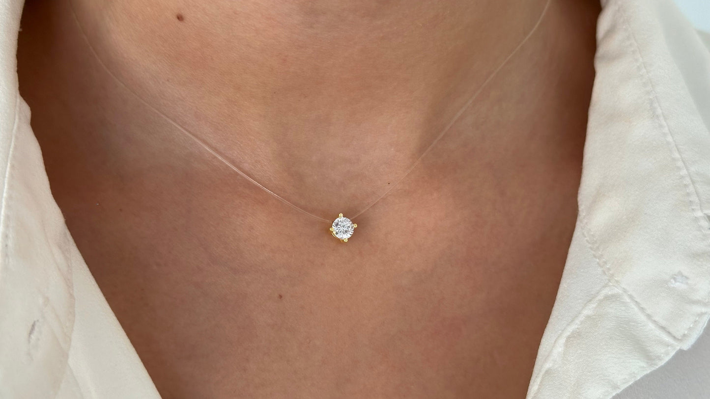 A delicate, clear fishing cord necklace with a small, round, clear cz solitaire diamond pendant. Minimalist 925 Sterling Silver 14k Gold-plated Handmade Jewelry Wedding Gifts for Bridesmaid.