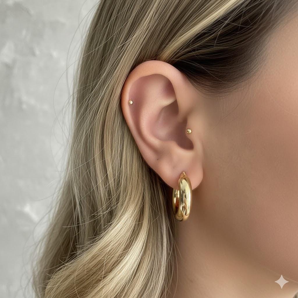 Chunky thick hoop earrings in silver, gold, and rose gold.