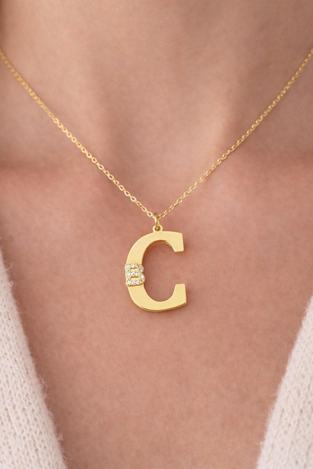 Gold couple initial necklace featuring two bold letters symbolizing love and connection