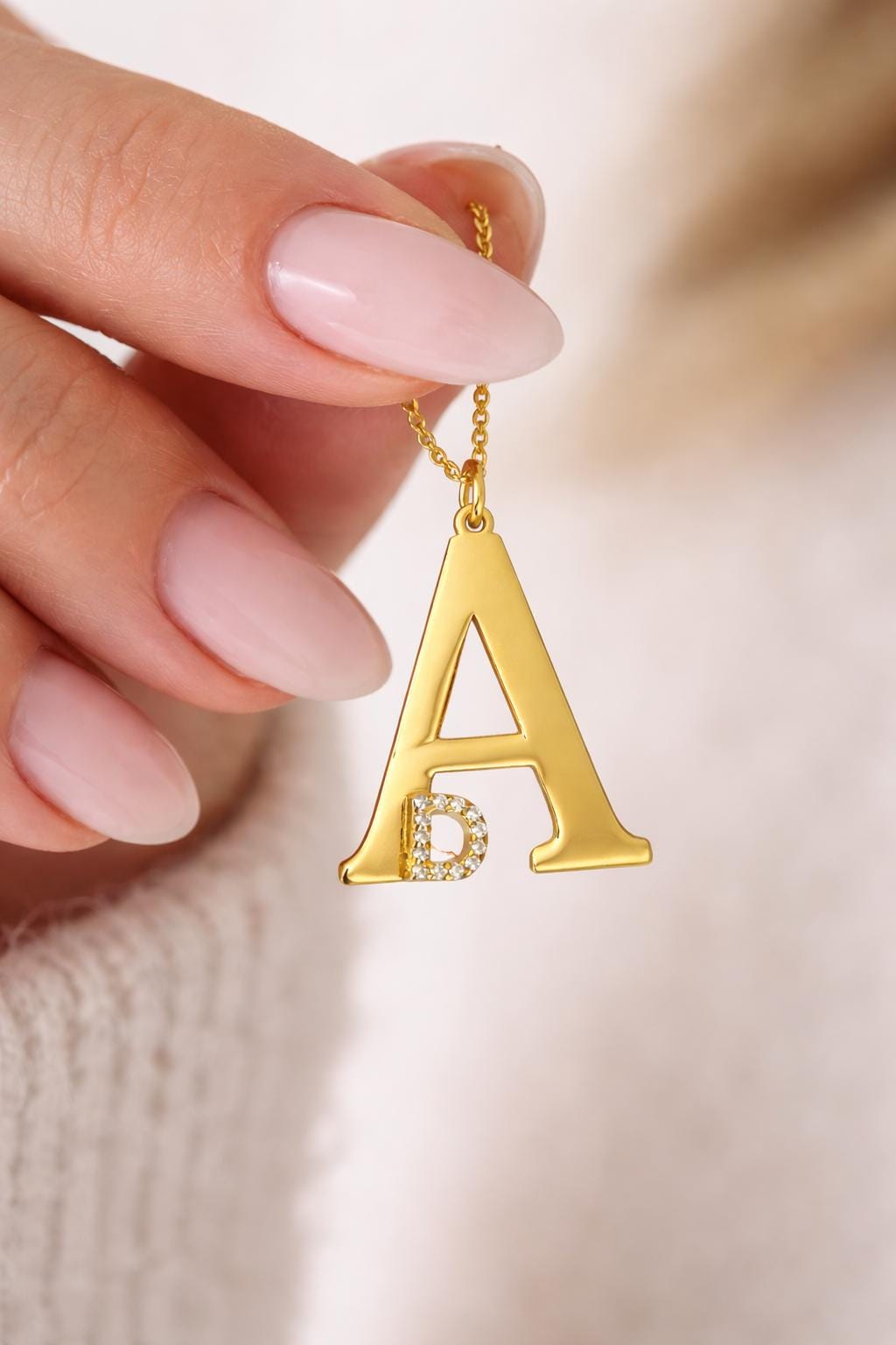 Large gold initial pendant necklace with small cubic zirconia accent letter detail