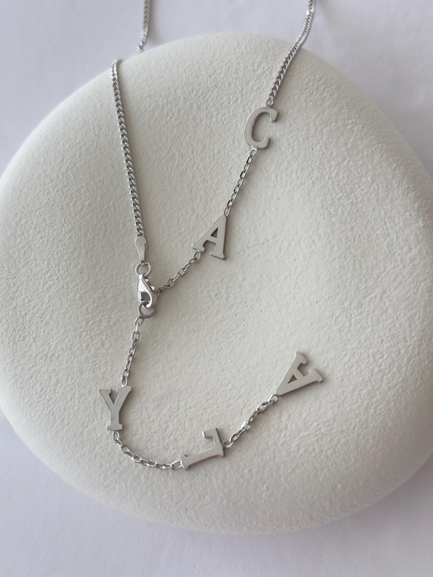 Sterling silver custom Y drop name necklace flat lay