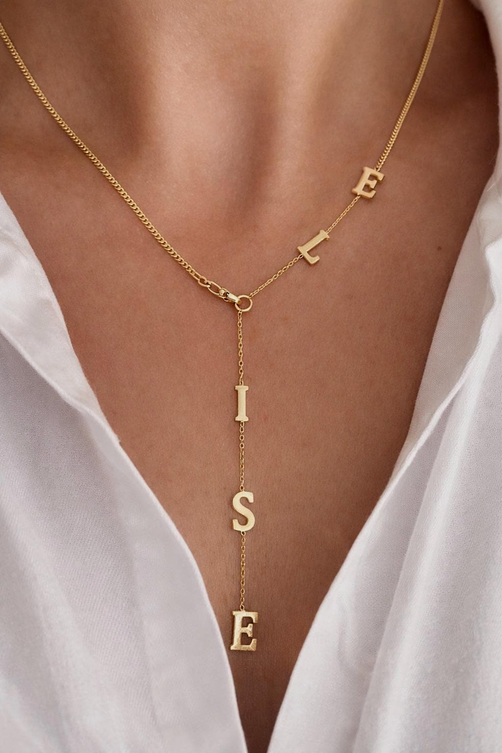 Personalized lariat name necklace in gold, custom drop letter necklace worn on model, dainty minimalist jewelry gift for her