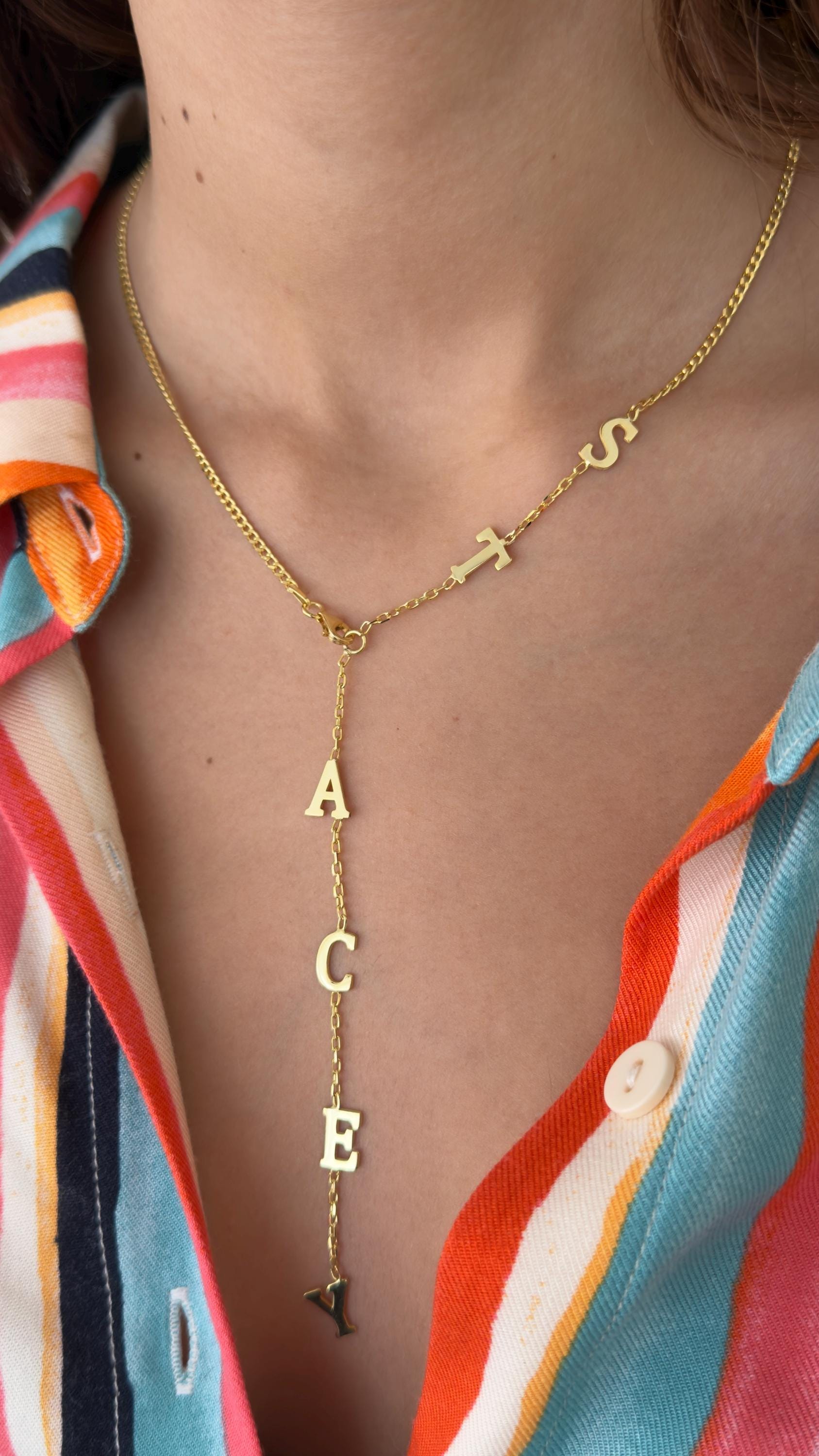 Gold lariat initial necklace worn on model, personalized long drop necklace