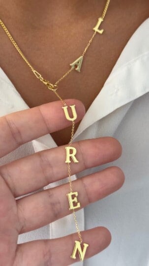 Close up custom gold name necklace letters, personalized lariat jewelry detail