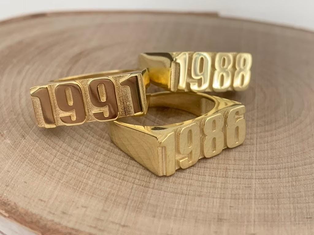 Bold statement year ring stacked with other jewelry pieces
