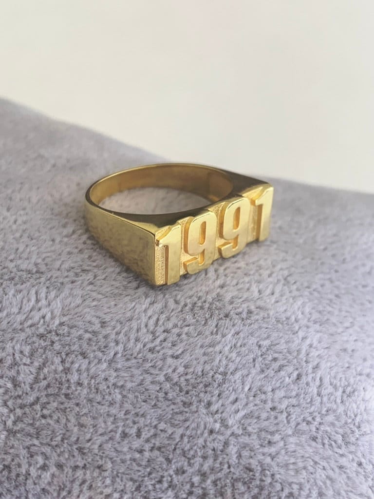 Elegant custom year ring packaged in a jewelry gift box