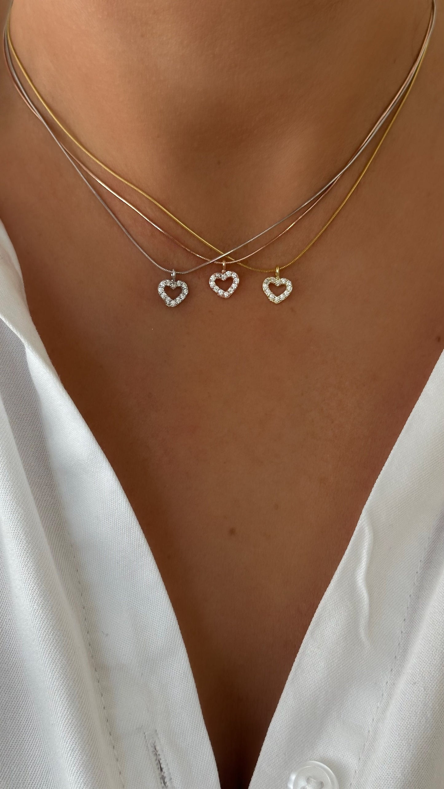 Close-up of silver snake chain necklace with diamond heart pendant, handcrafted Shineliz design.