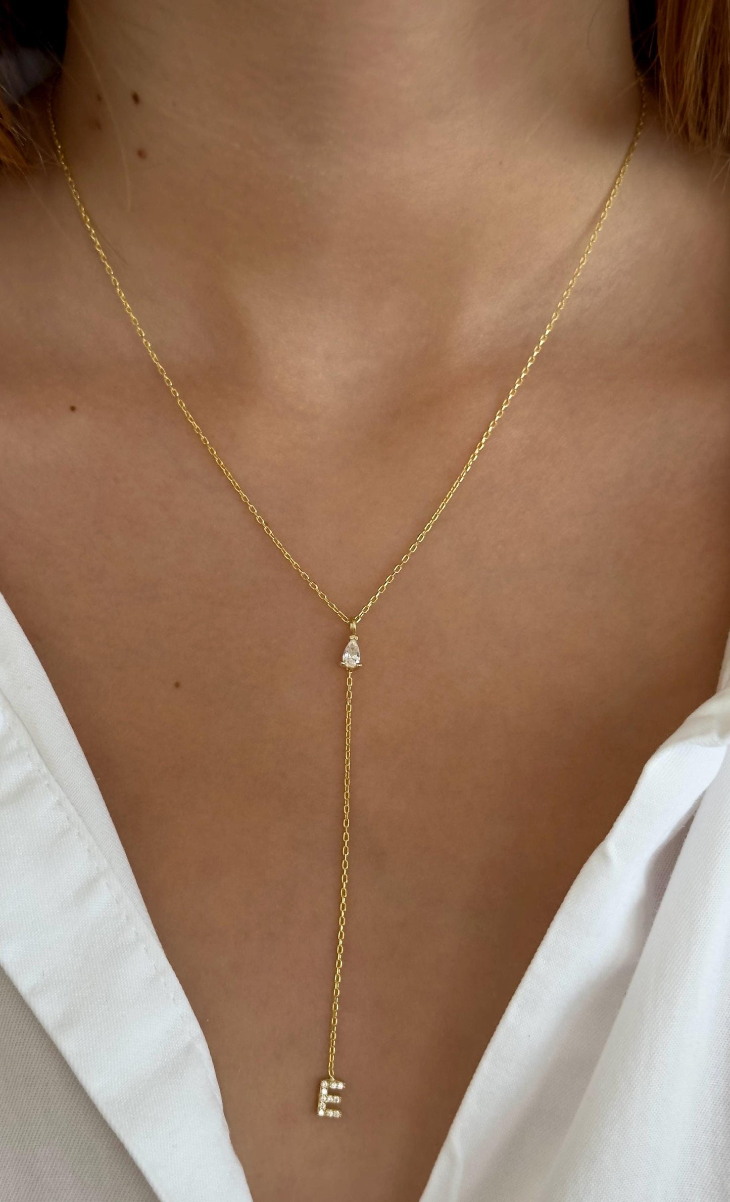 Gold initial necklace with letter E, dainty lariat drop design with cubic zirconia stone, elegant personalized jewelry gift
