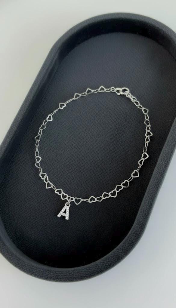 CZ gemstone letter charm detail on sterling silver bracelet.