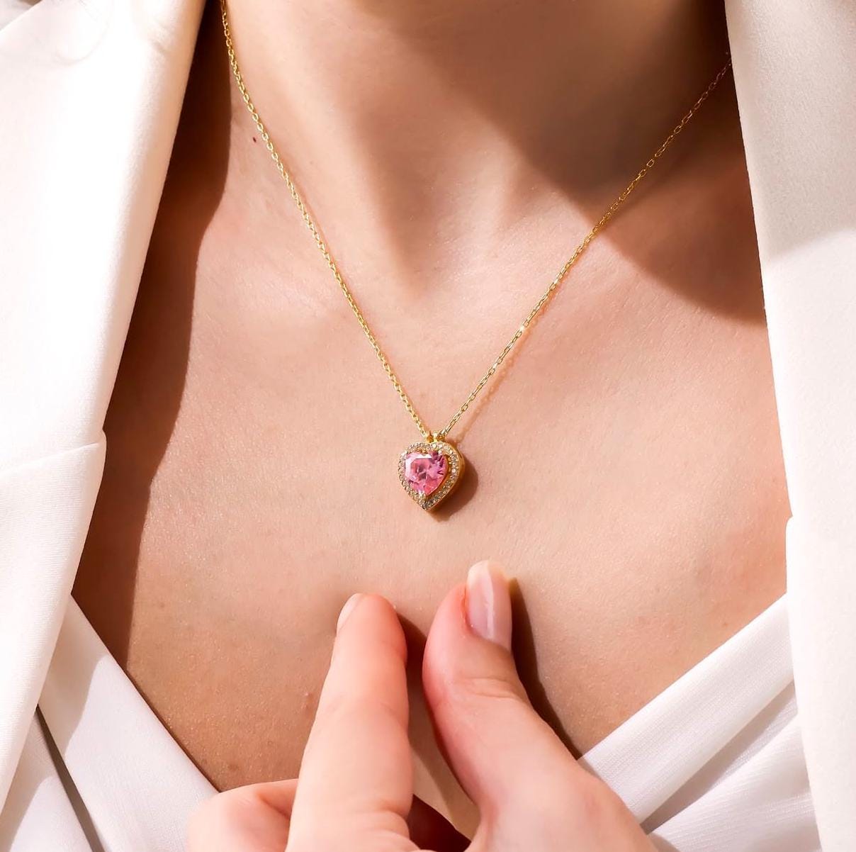 Woman wearing ShineLiz engraved name necklace with solitaire CZ heart pendant.