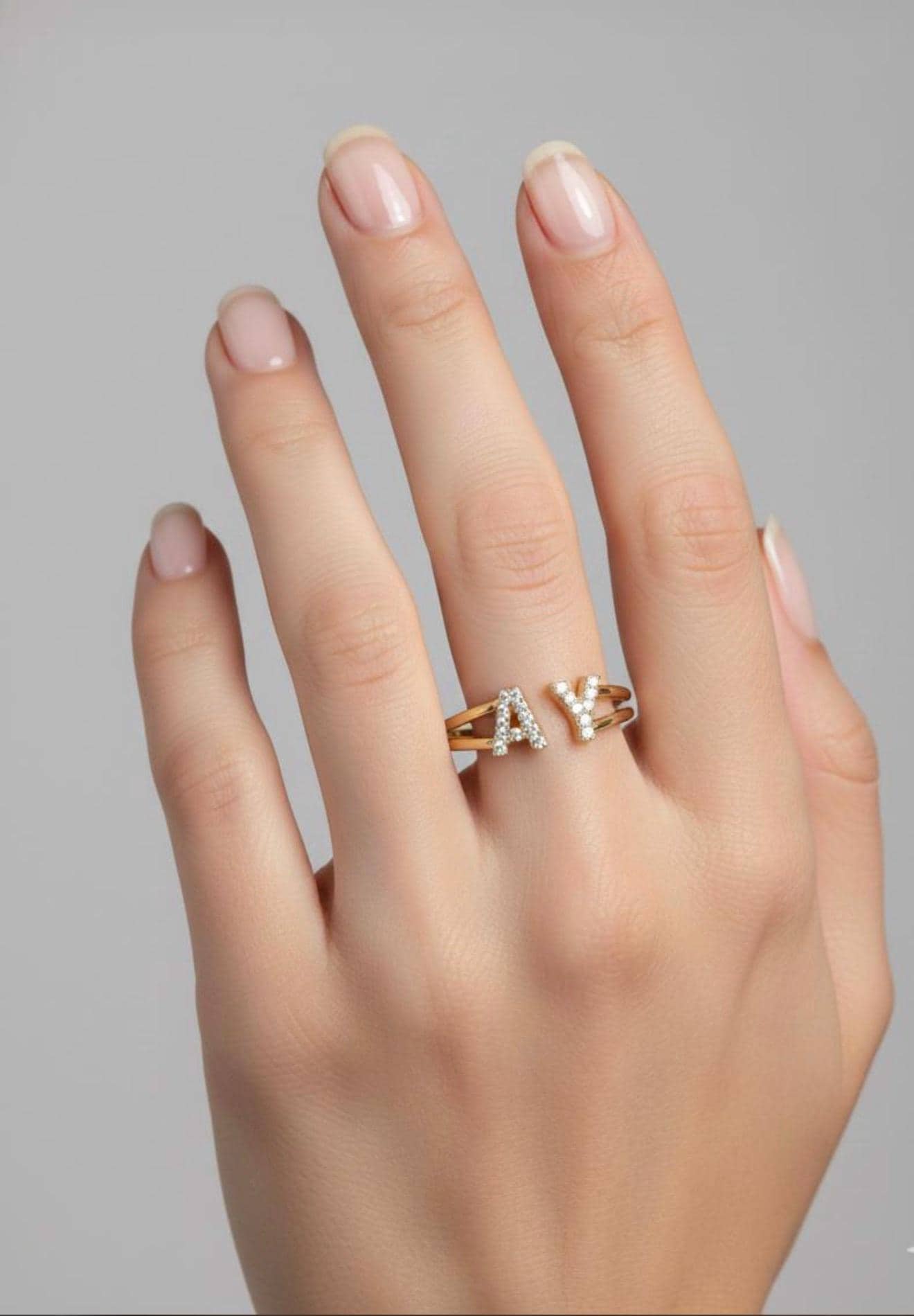 Promise ring with custom initials and gold CZ design.