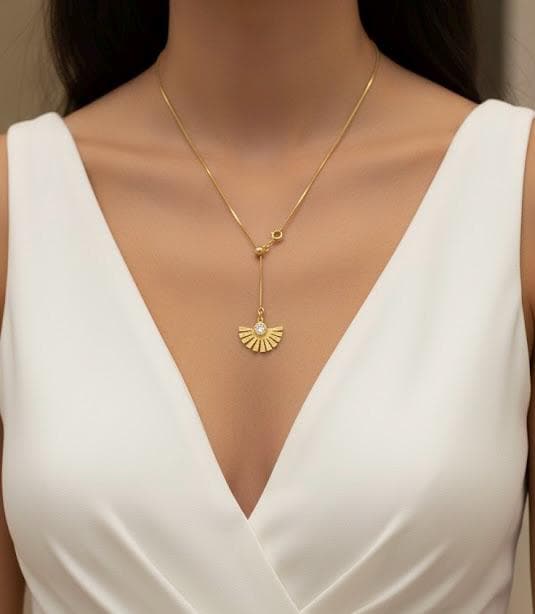 Adjustable gold lariat necklace showing sliding bead and fine snake chain detail