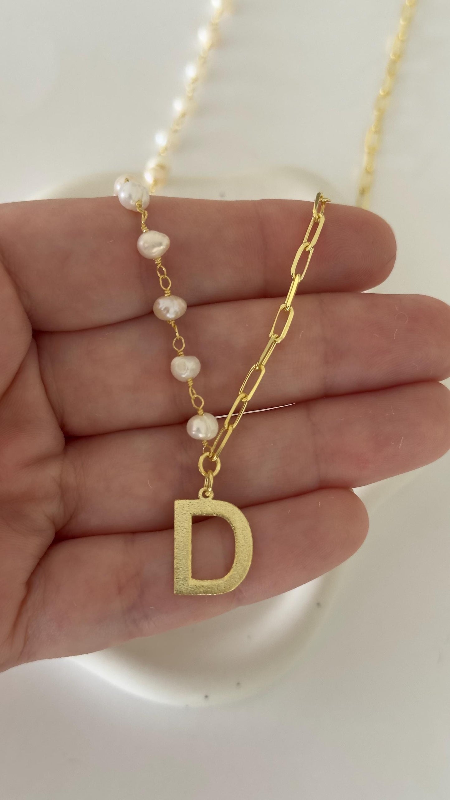 Gold pearl choker with initial charm