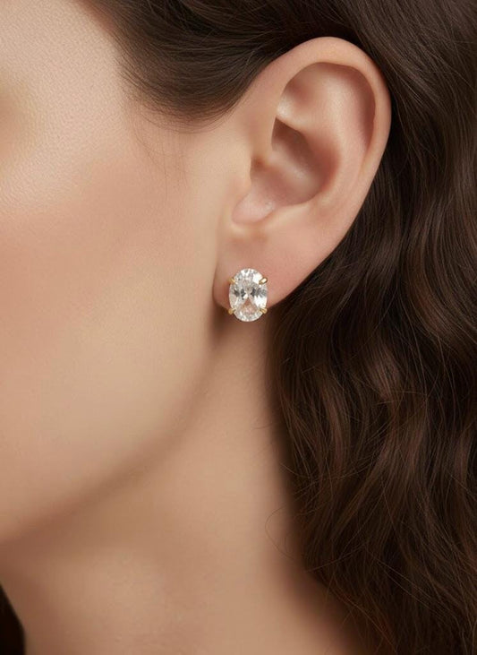 Dainty oval-cut solitaire diamond earrings for women.