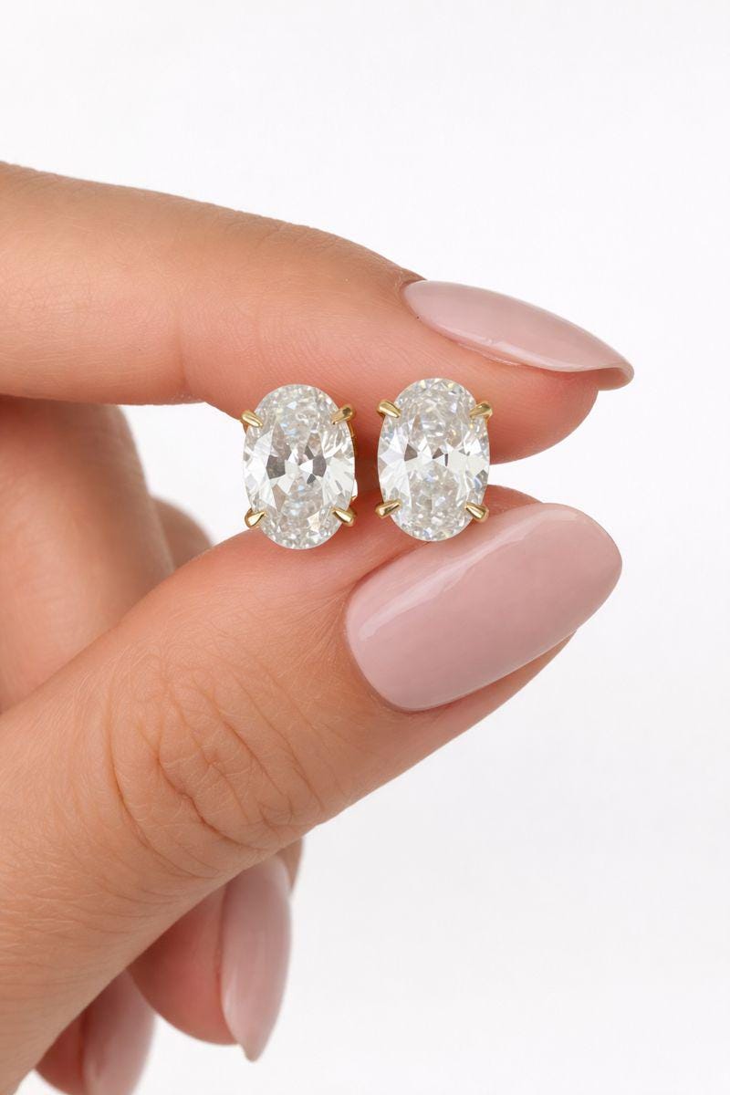 Oval cut lab diamond stud earrings in 14k gold plated sterling silver.