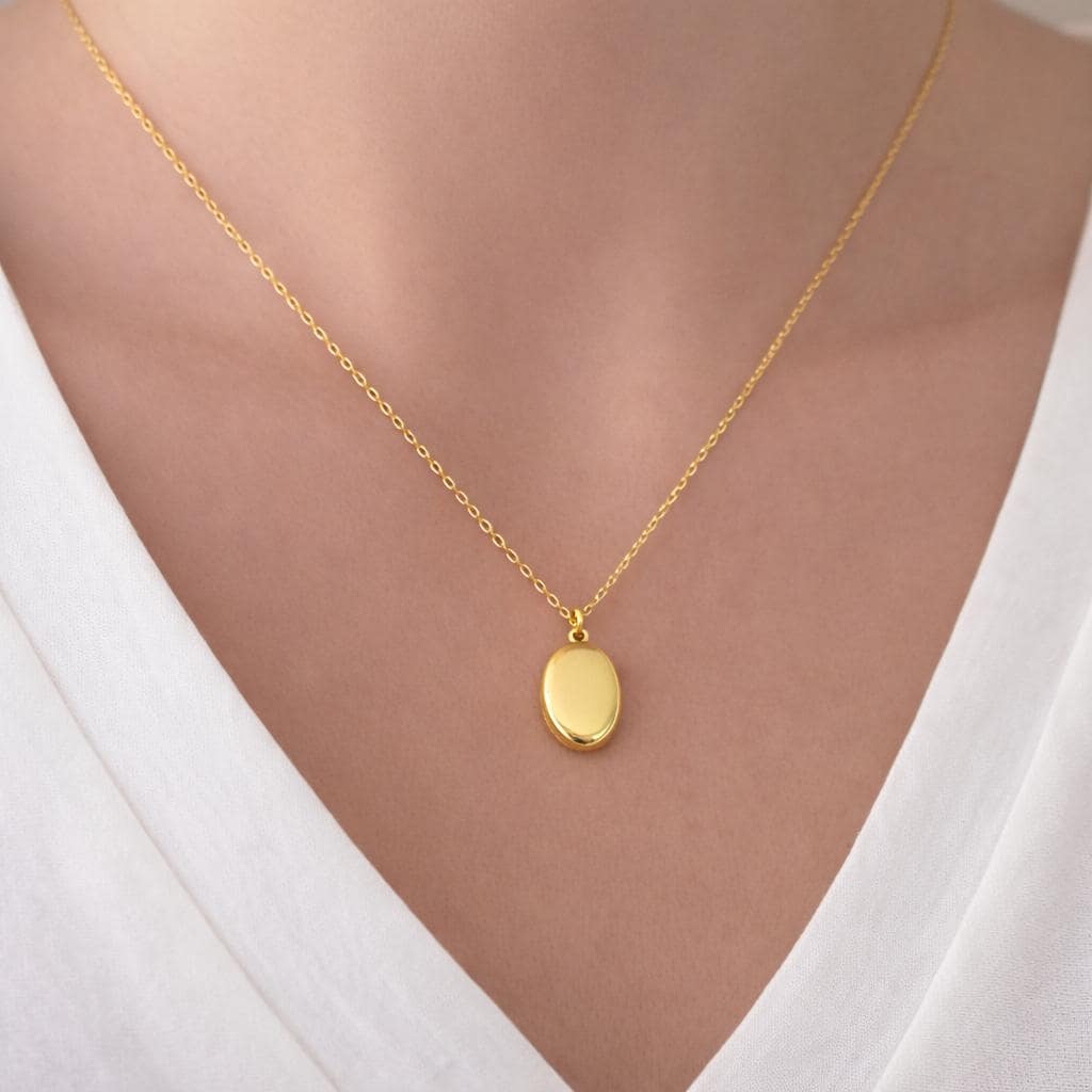 Oval locket necklace worn on model