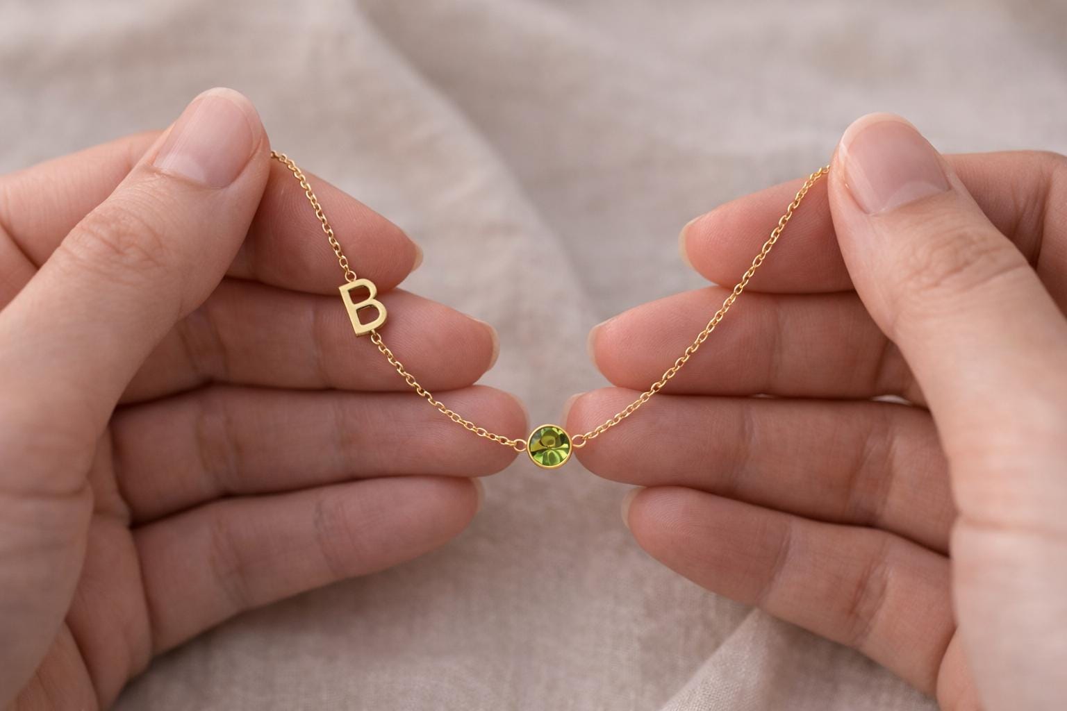 personalized initial necklace holding in hands