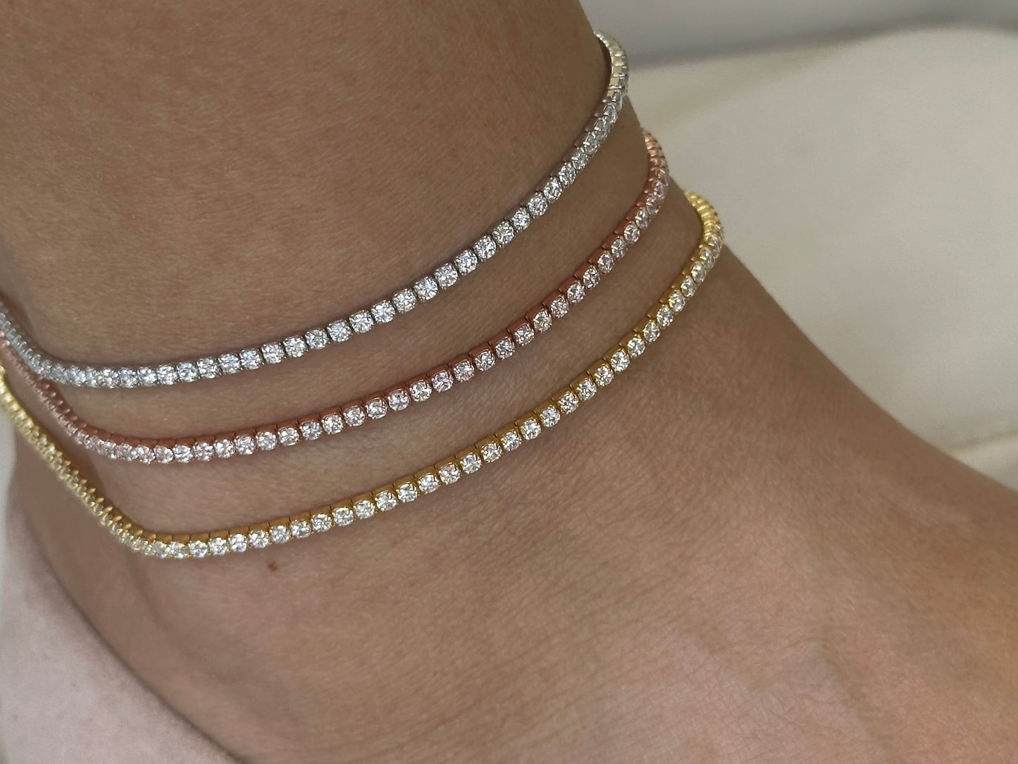 Three delicate anklets with a single row of small, clear cubic zirconia stones. The anklets are shown in silver, rose gold, and gold - 925 Sterling silver jewelry gifts for her