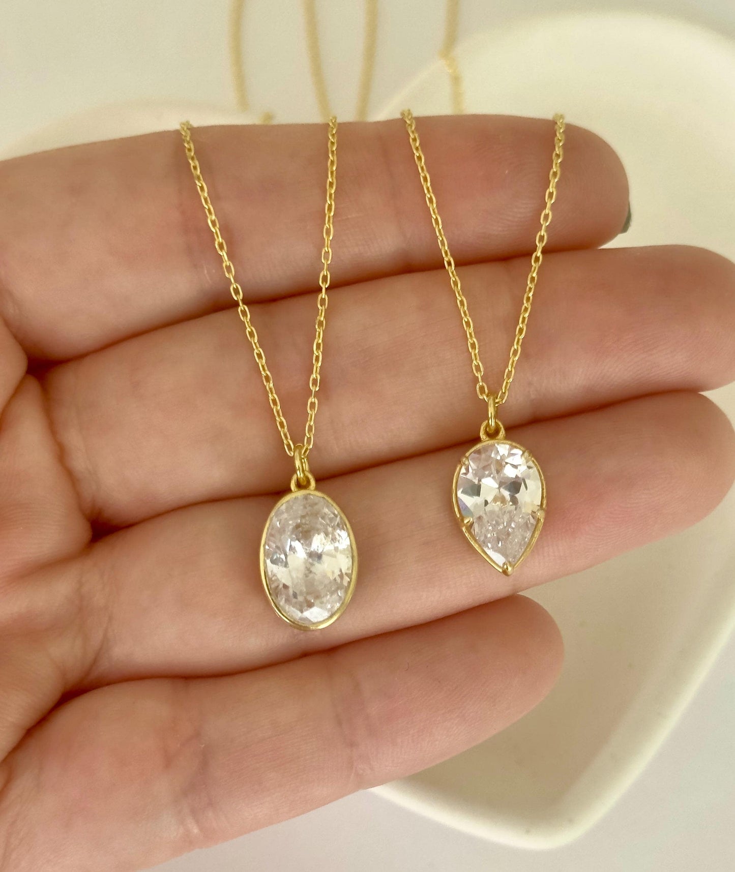 Oval and teardrop CZ diamond pendant necklaces in gold and silver finishes, elegant minimalist jewelry handcrafted by Shineliz.