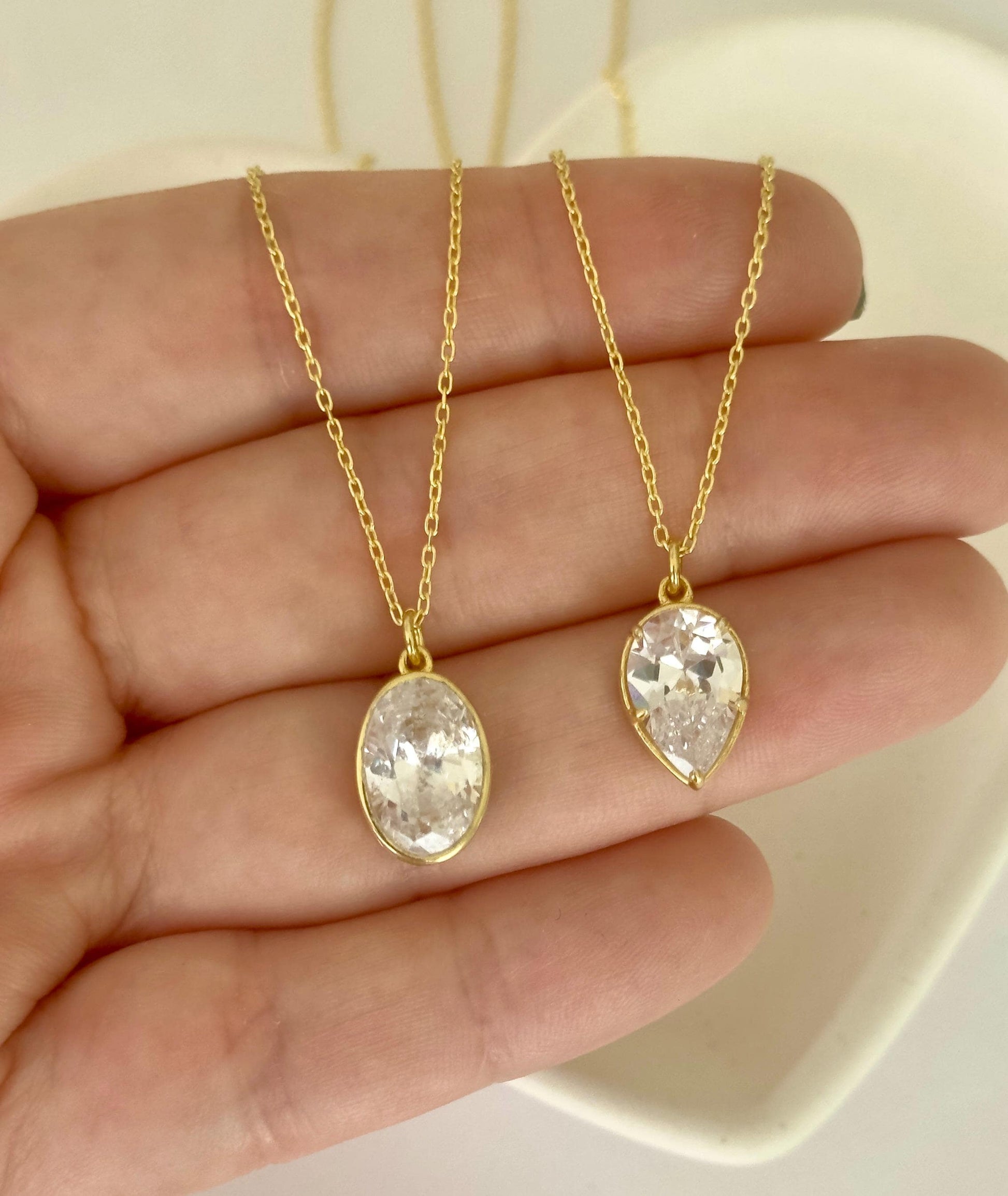 Oval and teardrop CZ diamond pendant necklaces in gold and silver finishes, elegant minimalist jewelry handcrafted by Shineliz.