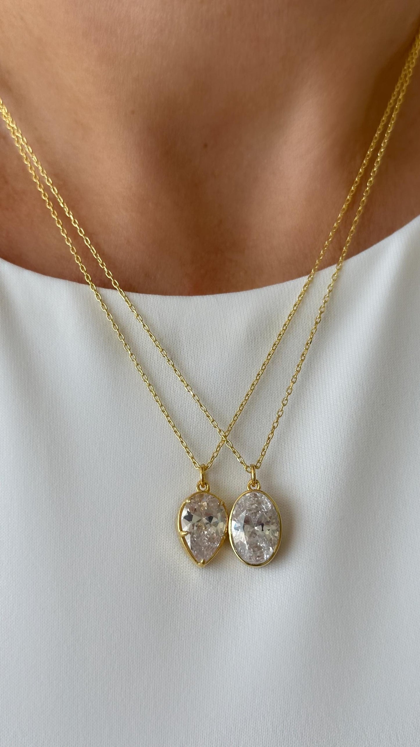 Minimalist teardrop pendant necklace made of 925 sterling silver with clear CZ gemstone, simple elegant jewelry for everyday wear.