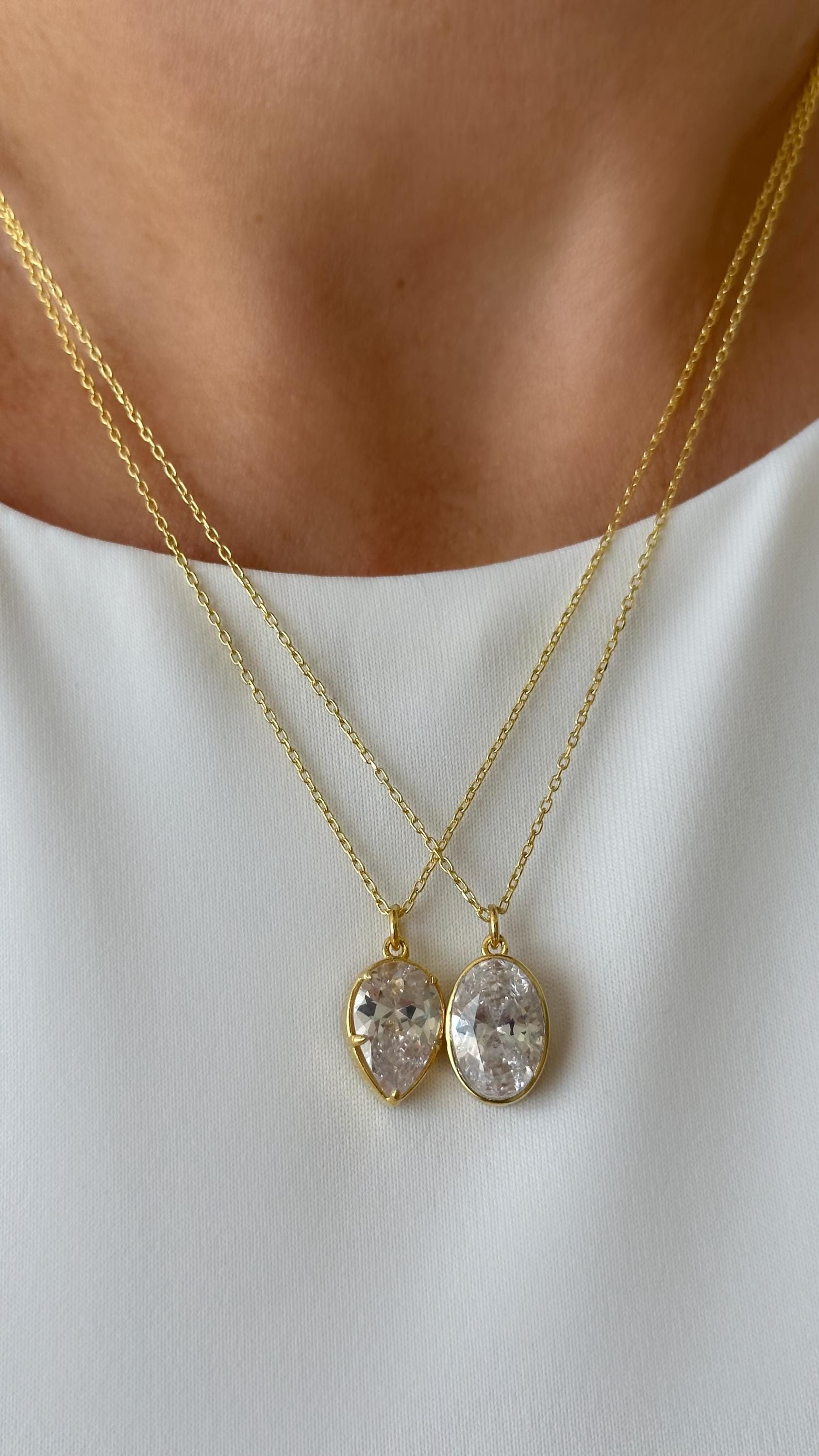 Minimalist teardrop pendant necklace made of 925 sterling silver with clear CZ gemstone, simple elegant jewelry for everyday wear.