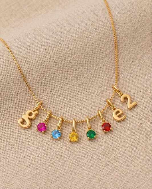 Custom letter birthstone necklace in gold with colorful gemstone charms, minimalist name necklace design, elegant personalized jewelry gift for her.