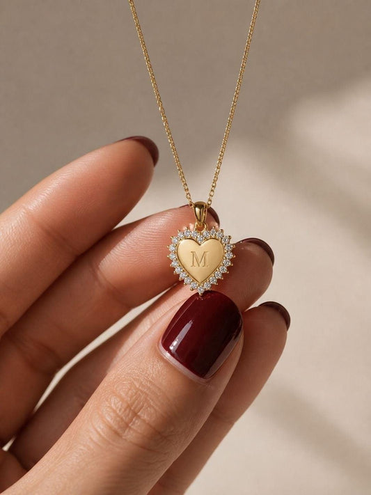 Gold heart diamond initial necklace with CZ halo pendant on model in warm sunlight