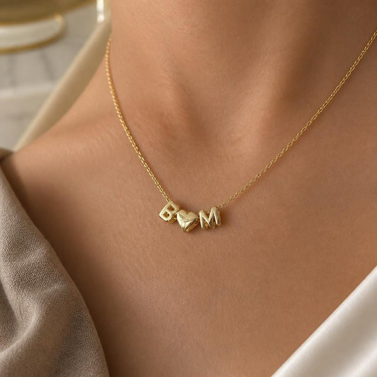 Personalized bubble heart initial necklace in 14K gold featuring 3D balloon letters on a dainty chain, custom name jewelry gift for women.