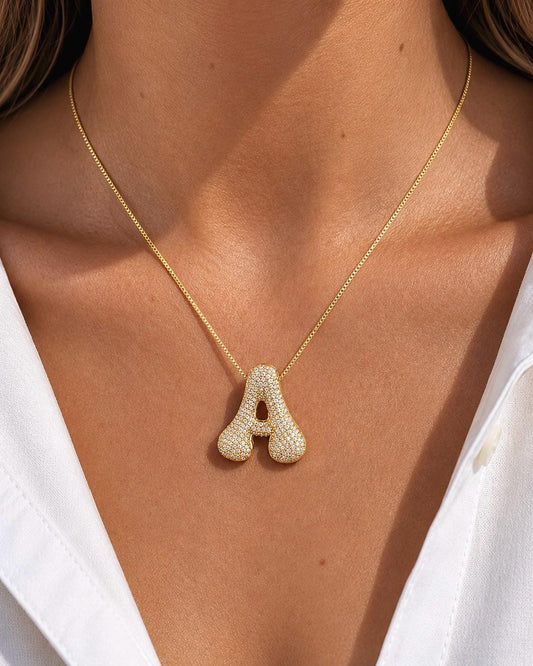 Jumbo diamond initial necklace with letter A pendant in 14K gold plated finish, pavé CZ stones, personalized bubble letter necklace shown on model, statement initial jewelry gift for women.