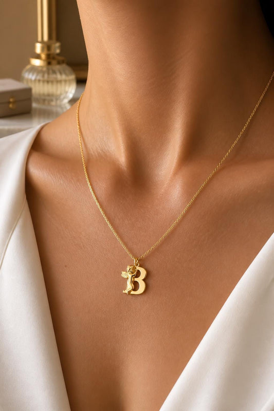 Gold angel letter necklace worn by model, personalized sterling silver initial necklace for everyday wear, layering and meaningful gifts.