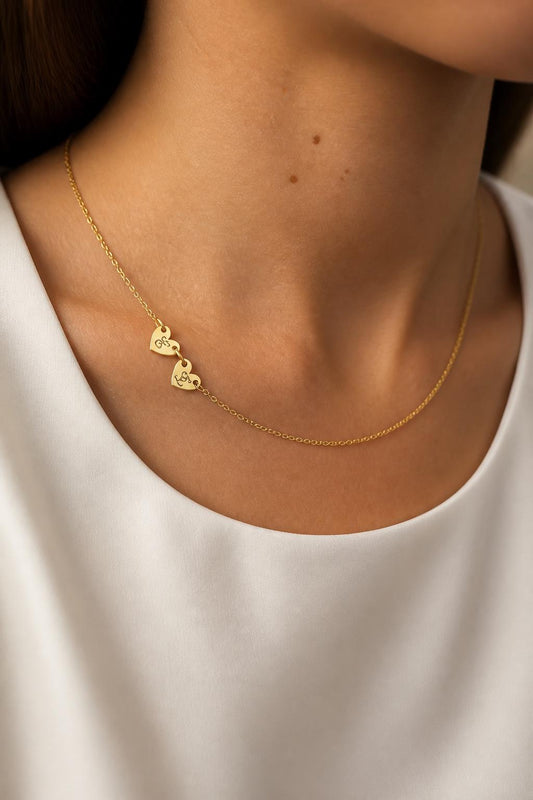 Custom heart letter necklace with two engraved initials on a delicate gold chain, modeled as a personalized gift for her.