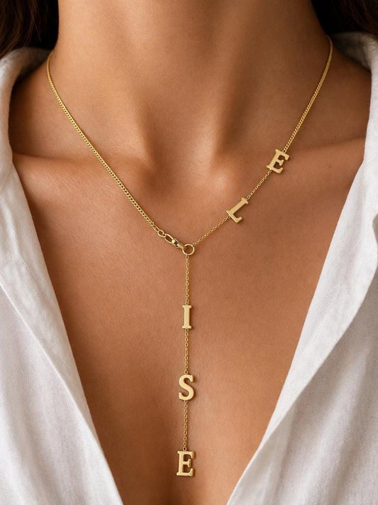 Personalized gold name necklace with vertical letter drop and modern lariat design