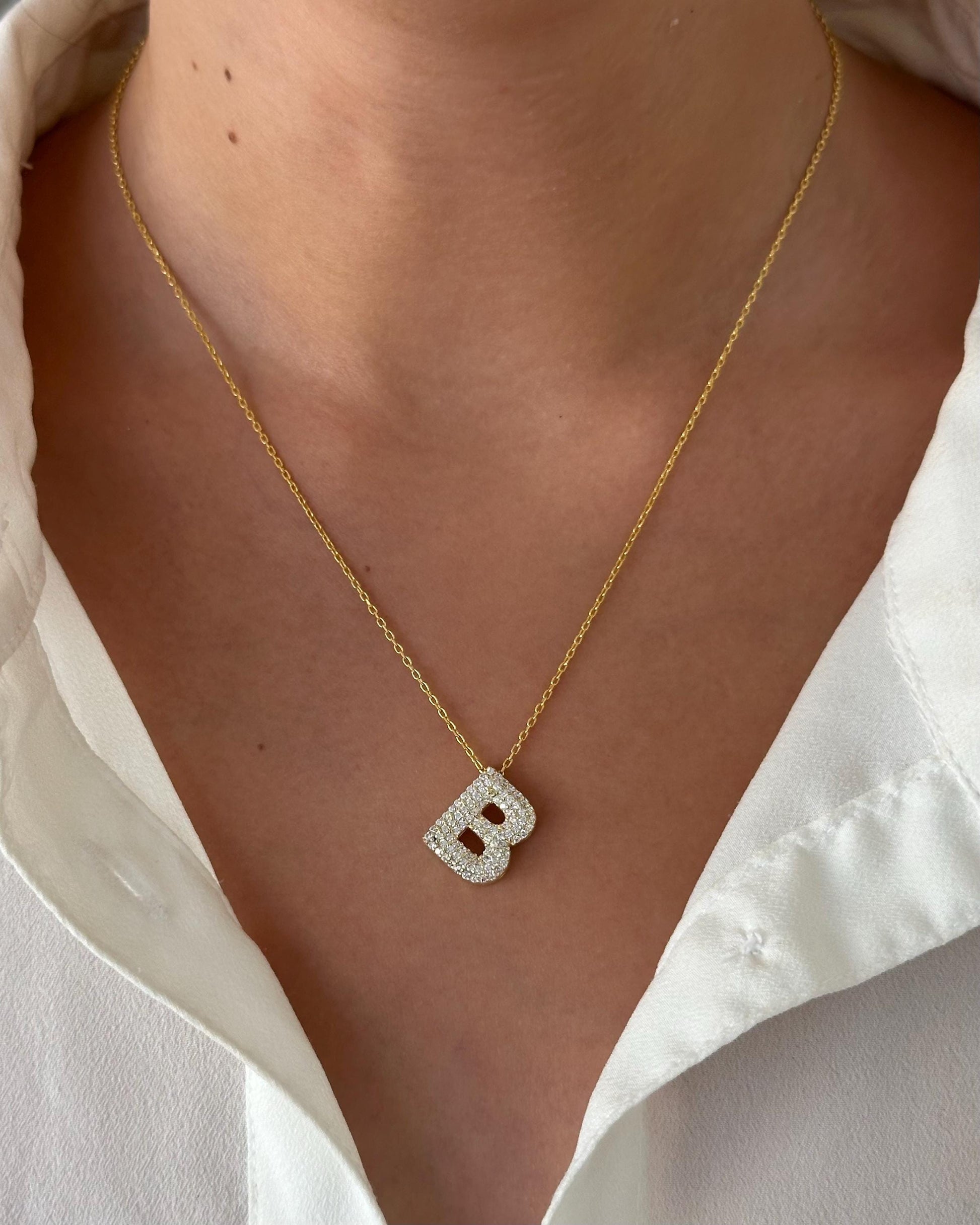 Custom gold and silver CZ diamond 3d bubble letter necklaces on a model, personalized gift for her.