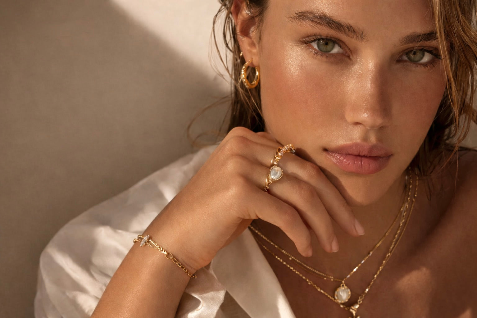 Model wearing Shineliz handmade sterling silver jewelry with layered necklaces and pearl pendant